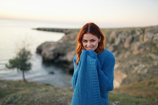 woman on nature blue plaid admires the landscape travel. High quality photo
