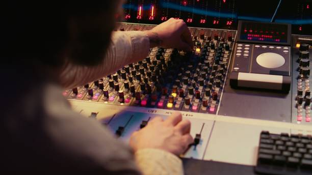 istock Male producer working at mixing panel in the professional recording studio 2120058947