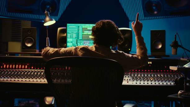istock Cheerful energic audio engineer dancing on his own music creation 2120059478