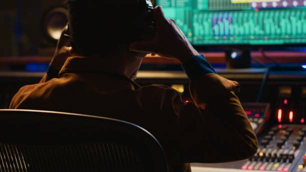 istock African american sound engineer recording and editing tracks in post production 2120061133