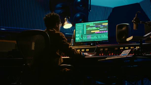 istock African american sound designer operates control desk mixer and audio software 2120062754