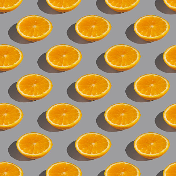 istock Seamless pattern of lemon or orange slices with shadow on a gray background. Flat layout 2120063286