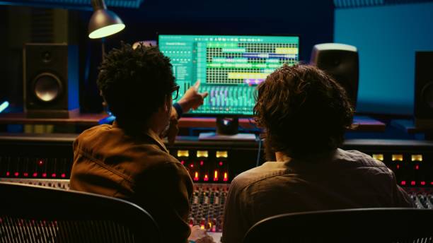 istock Team of sound engineers working on recording and editing tracks 2120064434