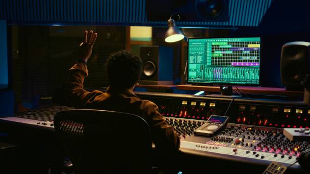 istock African american audio engineer counting down singer in sound booth 2120066457