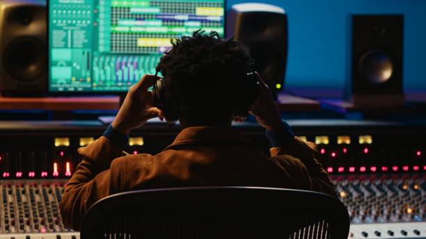 istock Professional tracking engineer using headphones to edit recorded tracks 2120078000
