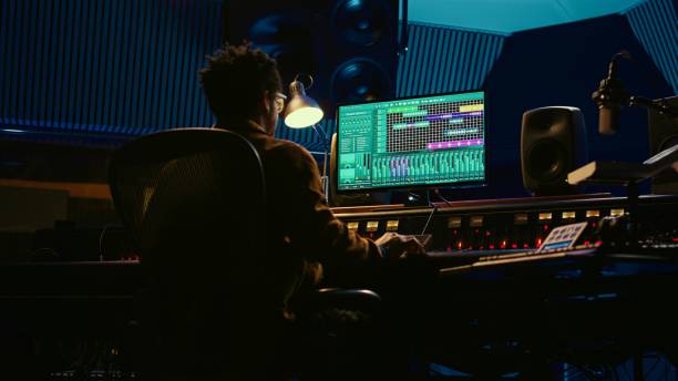 istock African american audio engineer uses compressor and mixer in professional studio 2120081757