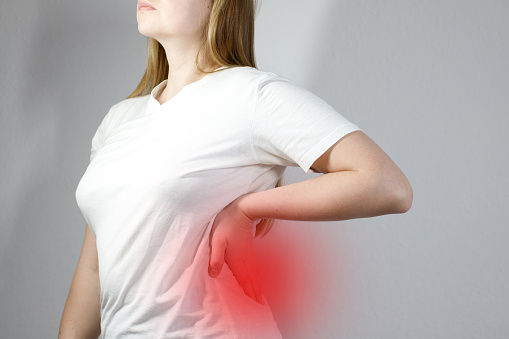 Kidney pain. Woman's back hurts