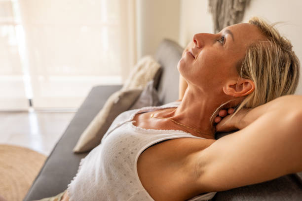 istock Pretty woman relaxing on a couch 2120115432