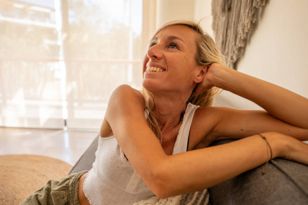 istock Happy woman relaxing at home 2120116495