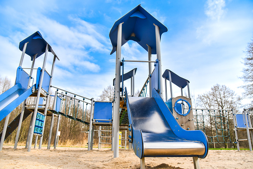 Children's play area with slides and climbing structures with ladders and bridges. Safe playground, pleasant and fun time, physical and mental development of children.