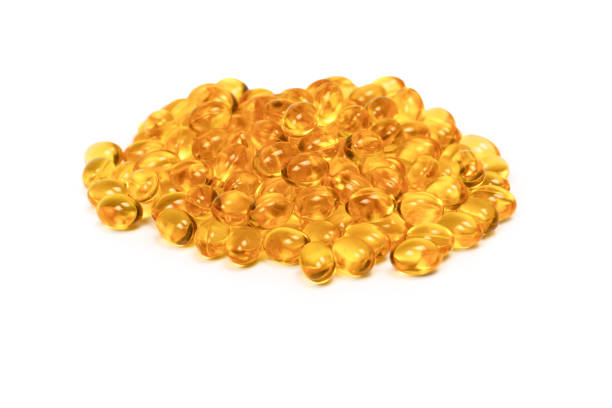 istock A group of yellow capsules isolated on a white background. 2120133371