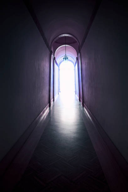 A spooky glowing light at the end of a hallway.