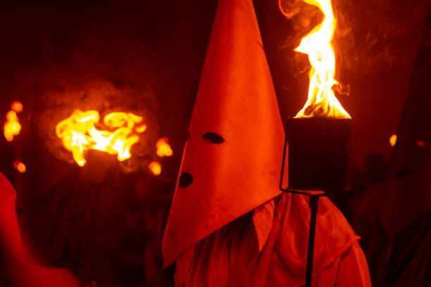 Goias, Goias, Brazil – April 06, 2023: Fogareu Procession.  A farricoco, holding a torch with fire, in the procession of Fogareu, a typical festival in the city of Goias in Brazil.