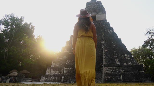 Woman exploring temple and Mayan ruins in Guatemala