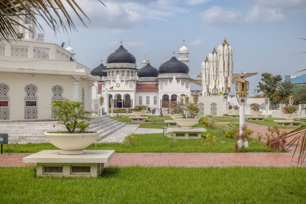 The great mosque, Banda Aceh, Sumatra, Indonesia - January 15th 2024:  Architectural details of the large mosque with domes and minarets