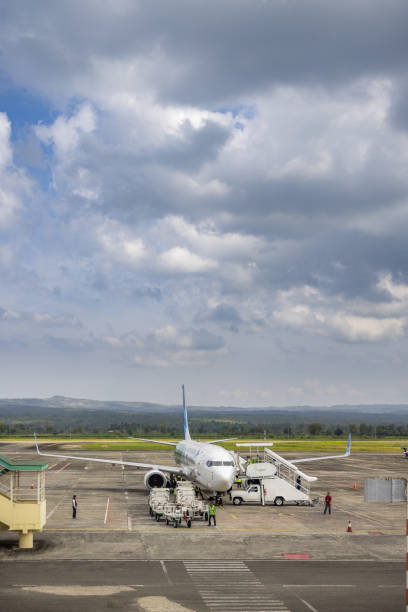 Sultan Iskandar Muda Int'l Airport, Banda Aceh, Sumatra, Indonesia - January 15th 2024:  Airport staff around a Boeing 737 passenger plane