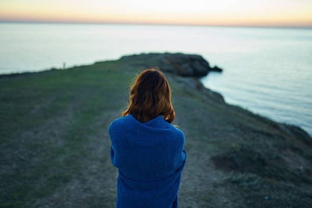 woman hiker admires nature landscape river back view. High quality photo