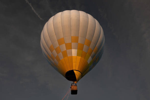 Colorful hot air balloon flying above the clouds