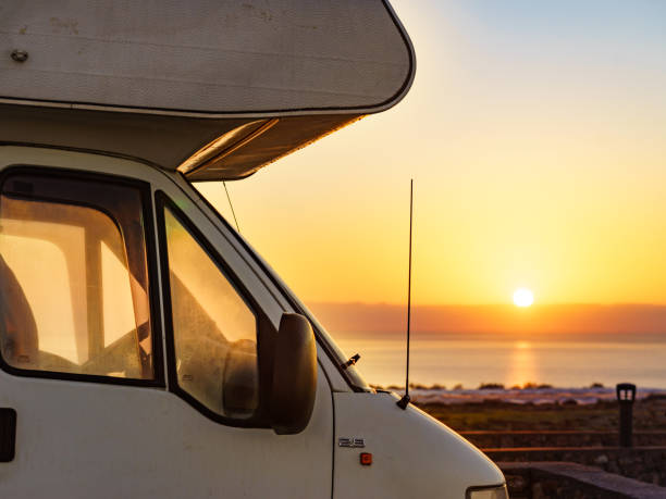 istock Camper car on coast at sunrise 2120233741