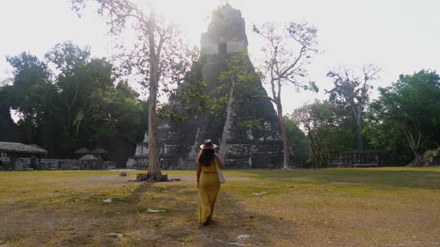 Woman exploring temple and Mayan ruins in Guatemala