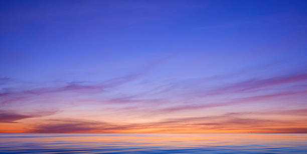 istock Idyllic sunset sky background over sea with colorful sunlight reflection on motion blur of flowing water surface 2120240095