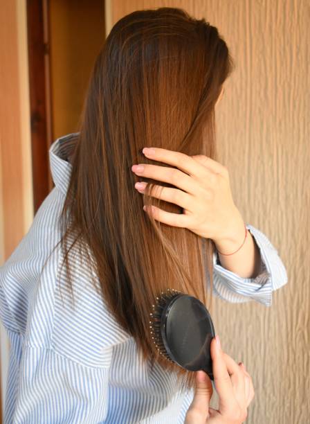istock A woman combs her hair 2120291065