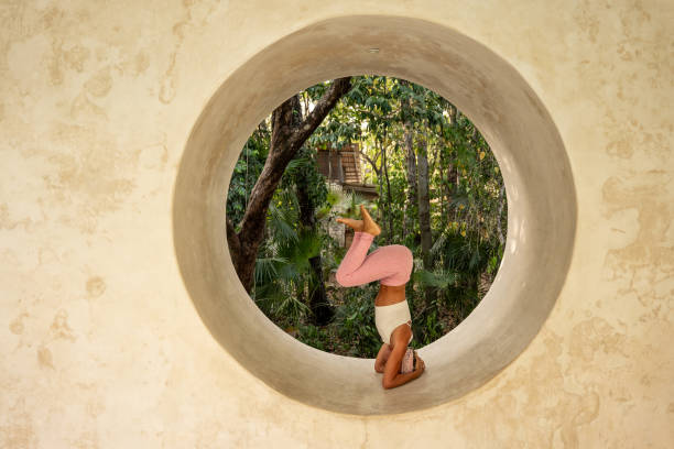 istock Side view of a female yogi performing a headstand 2120294381