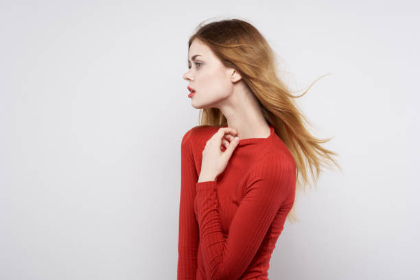 Young stylish woman on gray background