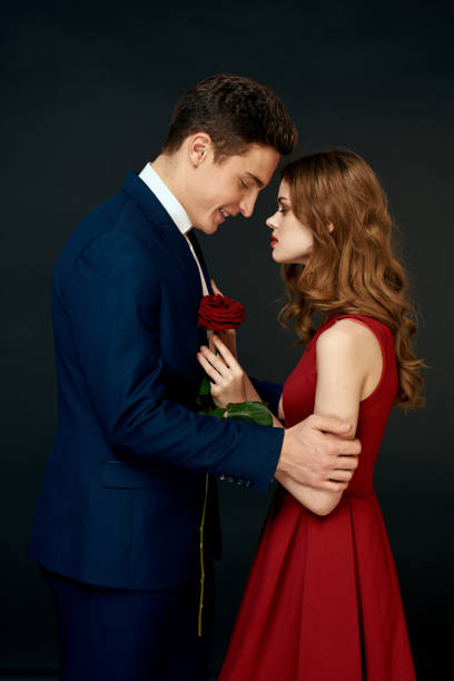 istock luxury couple hug romance relationship rose over dark isolated background 2120304114
