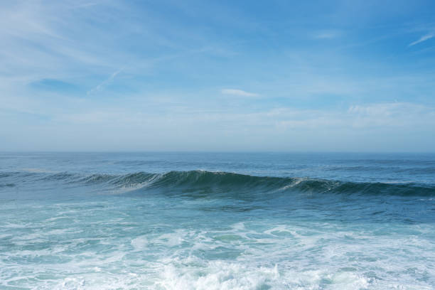 Medium waves crashing on the beach. Salvador city, Bahia state, Brazil.