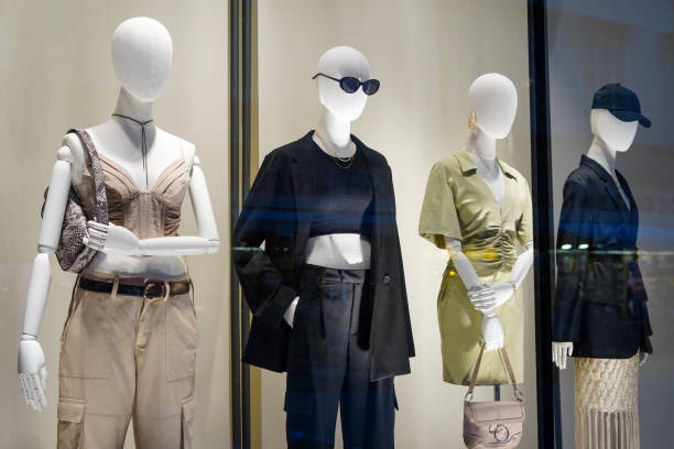istock four mannequins in stylish clothes shop window 2120310581