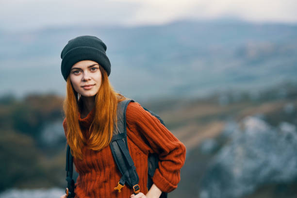 istock woman hiker with backpack smile landscape mountains travel 2120321939
