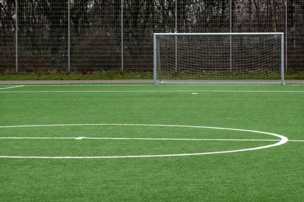 istock soccer pitch, center circle and goal 2120322473