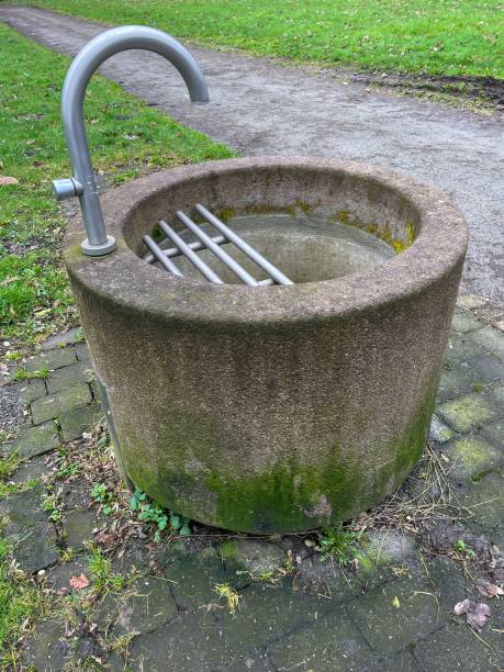 istock concrete fountain with water crane 2120342159