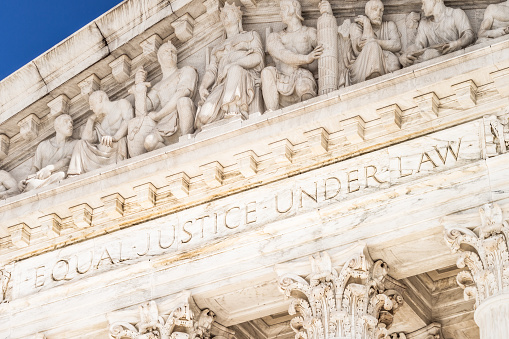 The words 'Equal Justice Under Law' above the columns of the facade of the Supreme Court Building in Washington DC.