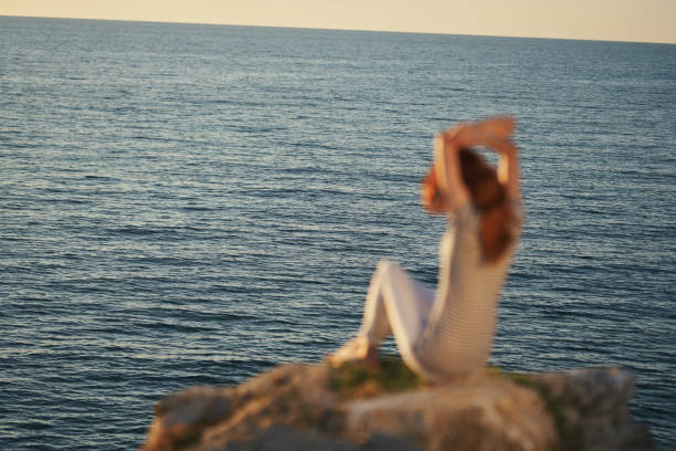 traveler by the sea at sunset back view. High quality photo