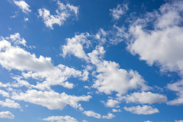 istock Fluffy clouds in the blue sky at sunny day 2120356519