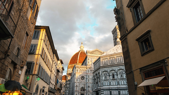 Beautiful old historic city of Florence in Italy with its vintage buildings and streets at sunset. Amazing Cattedrale di Santa Maria del Fiore. Street view. Holidays and travel in Italy