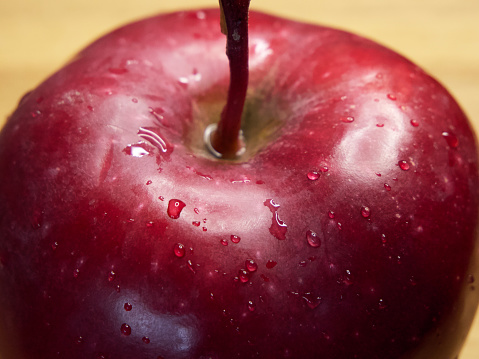 Water droplets on a red apple. A macro shot of an apple of the Red Chief variety.