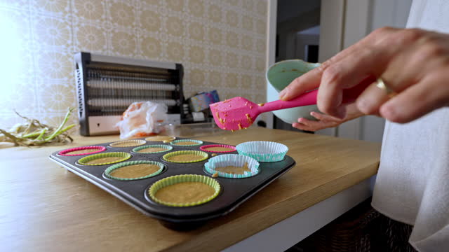 Efficient Use Of Batter By Woman To Finish Cupcake Recipe Without Any Waste