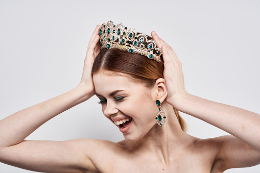 portrait of a woman with a crown on her head makeup model close-up lifestyle. High quality photo