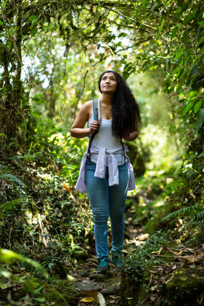 Happy woman walking in the forest