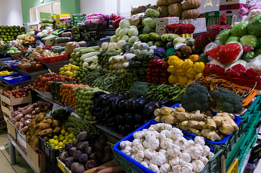A vegetable stall with fresh produce in a market place.
