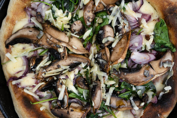 istock Top view of a mushrooms and spinach pizza 2120477460