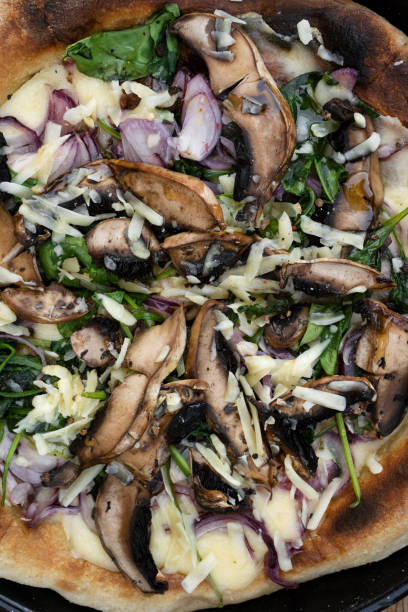 istock Top view of a mushrooms and spinach pizza 2120477463
