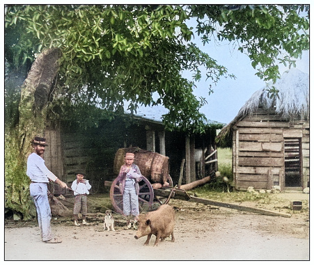 Antique black and white photograph of people from islands in the Caribbean and in the Pacific Ocean; Cuba, Hawaii, Philippines and others: rural home in western Cuba