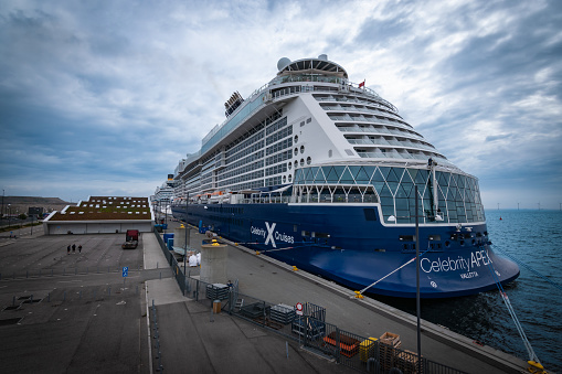 Copenhagen, Denmark - July 29, 2023: Celebrity Cruise ship Apex docked in port of Copenhagen on a cloudy day in summer.