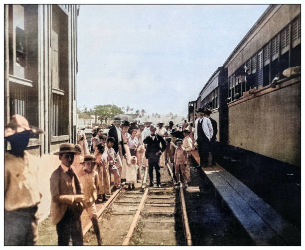 Antique black and white photograph of people from islands in the Caribbean and in the Pacific Ocean; Cuba, Hawaii, Philippines and others: Train station, Esperanza, Cuba