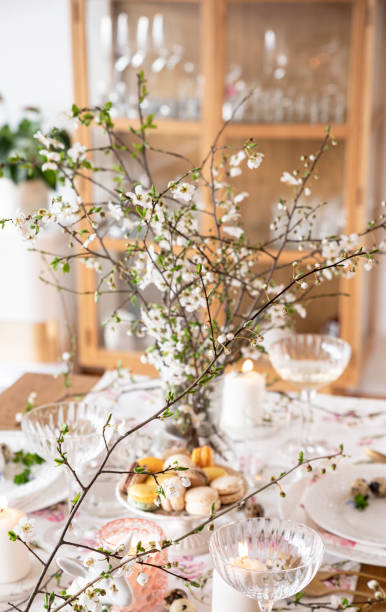 istock Spring Easter decor. Easter table setting. Flowers and dishes and candles for a festive dinner 2120537693