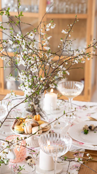 istock Spring Easter decor. Easter table setting. Flowers and dishes and candles for a festive dinner 2120547631